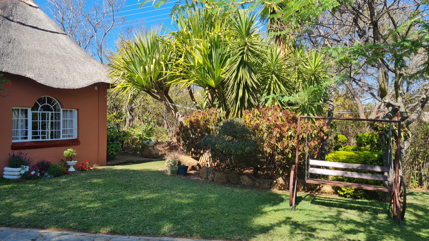 Garden swing and landscaped lawn at Lynn's Guesthouse